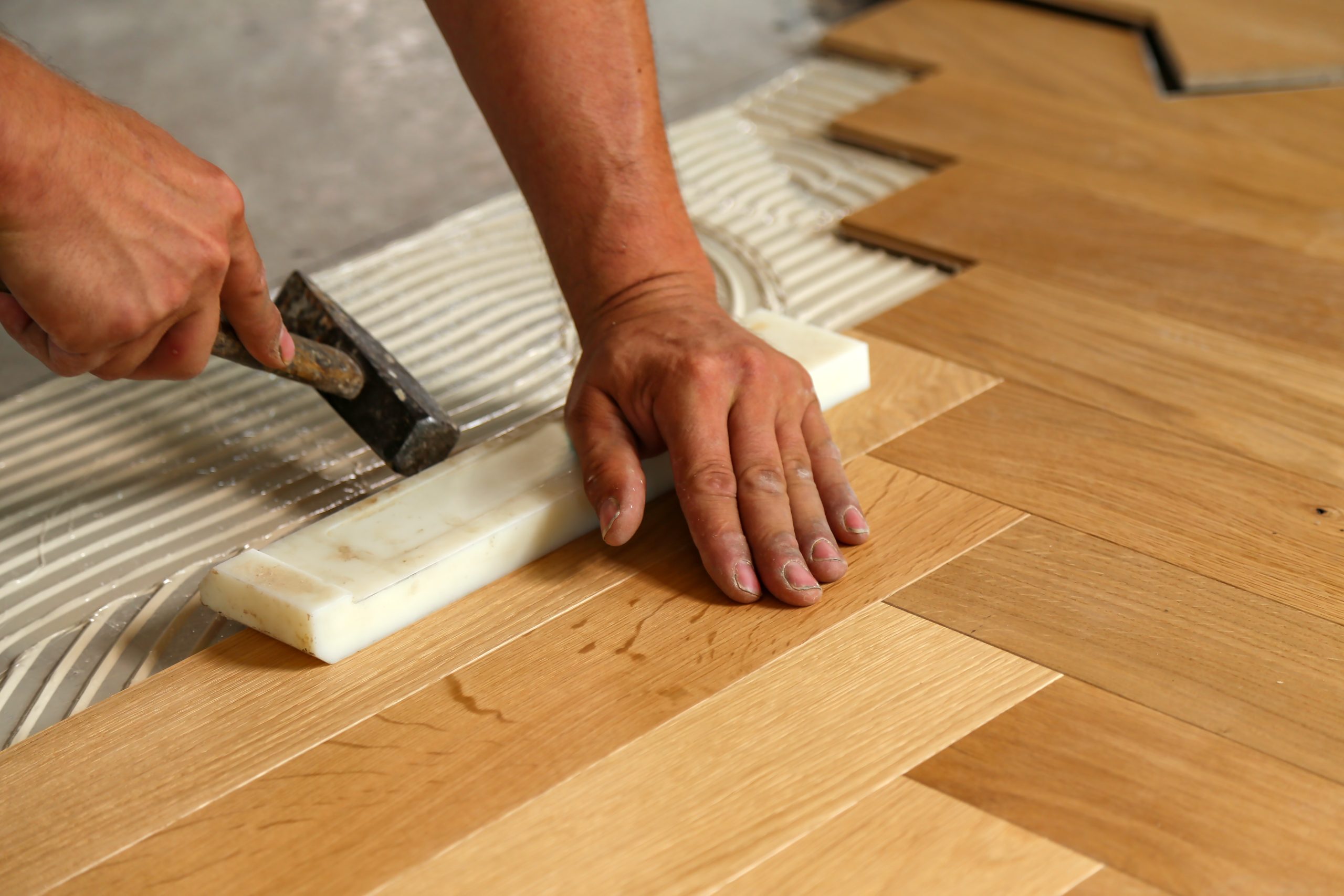A worker installing parquet flooring